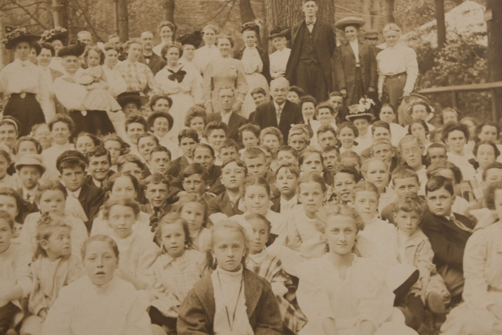 Lot 137 - Antique Boarded Photograph Of Large Group Of Children In Woodland Clearing With Adults Standing Behind, Likely Summer Camp, Photographed By Moon Co. Photo, Worcester, Massachusetts, June 28, 1910