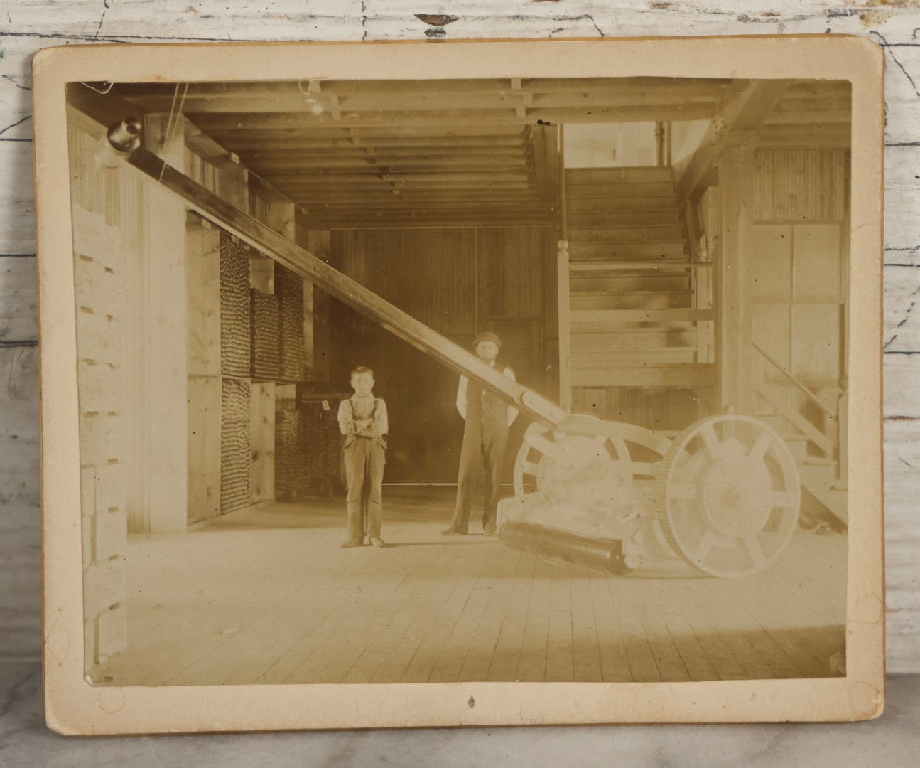 Lot 138 - Antique Boarded Photograph Of Large Hammer Machinery Display With Two Workers, Related To Caldwell Harness Exhibit At World's Fair, With Detailed Manuscript Note On Verso