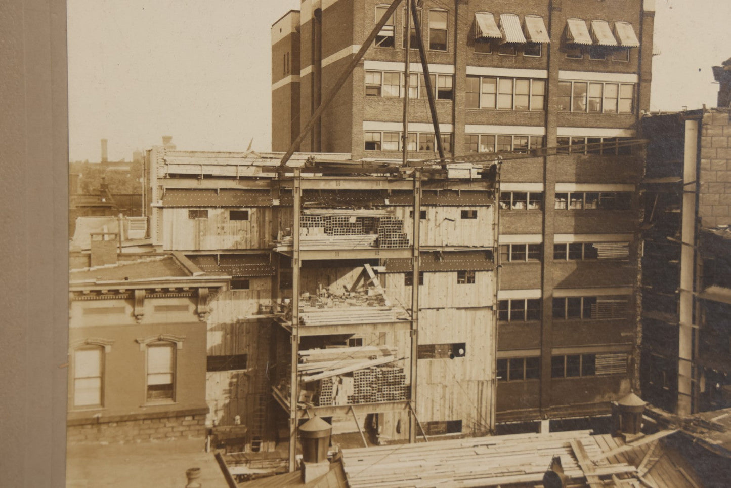 Lot 140 - Antique Boarded Photograph Of Urban Construction Scene With Multi-Story Buildings, Rooftop Water Tank, And “Wallace” Sign Visible