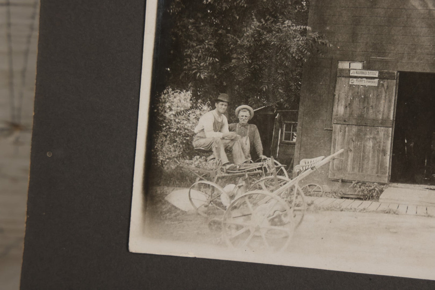 Lot 141 - Antique Boarded Photograph Of Garage With Early Automobile, Kendall's Spavin And Flint's Powder Signage, Three People With Wagon