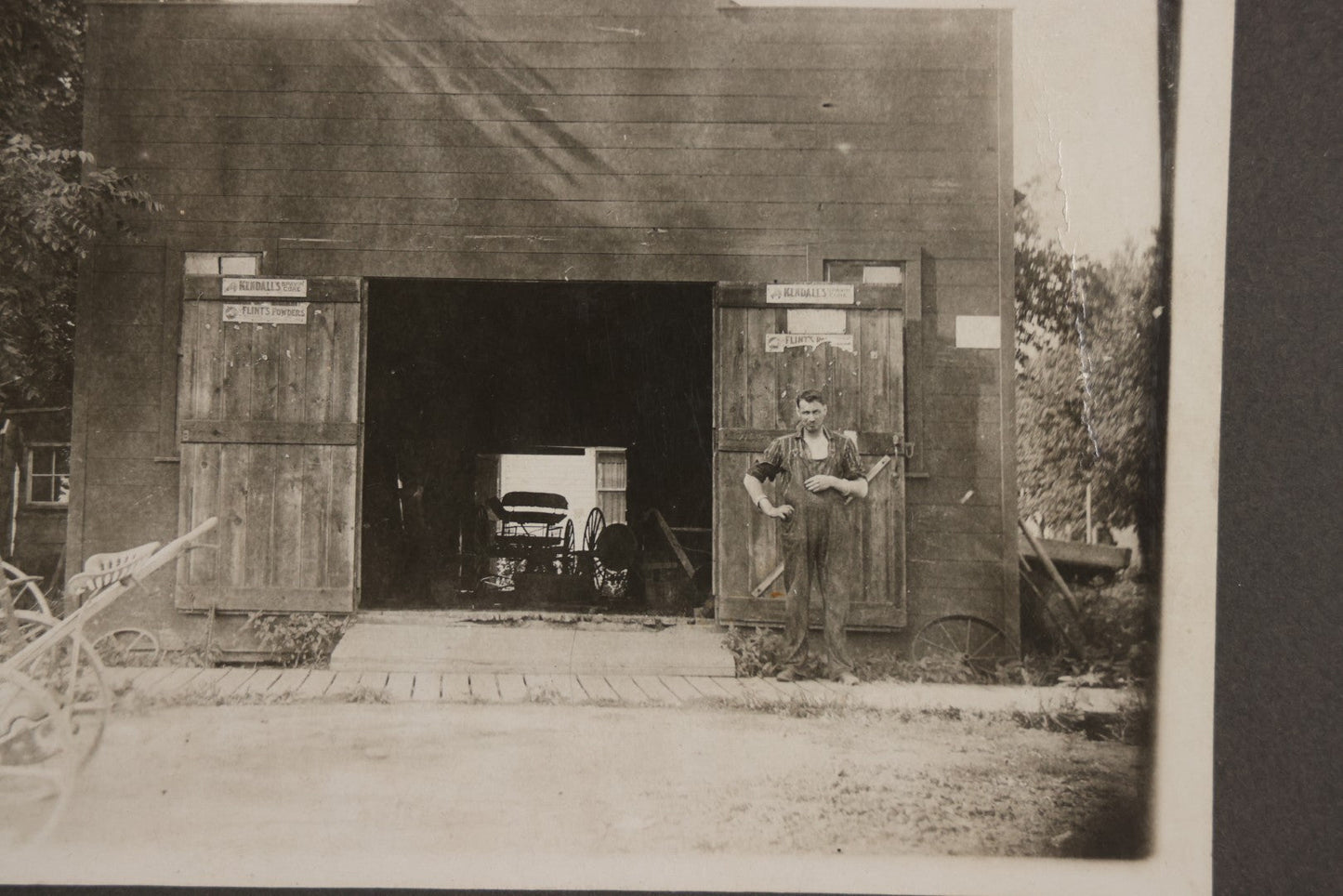 Lot 141 - Antique Boarded Photograph Of Garage With Early Automobile, Kendall's Spavin And Flint's Powder Signage, Three People With Wagon
