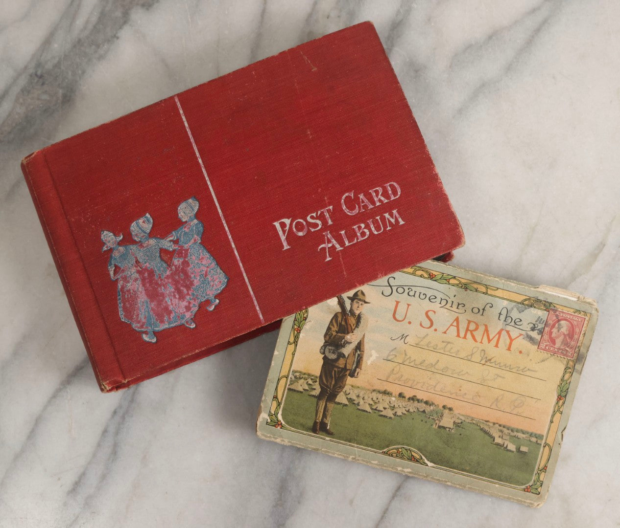 Lot 143 - Antique Postcard Album Containing 50 Postcards Including Numerous Real Photo Postcards R.P.P.C.S With World War One Soldiers, Sailor, Other Portraits, And U.S. Army Souvenir Postcard Folder