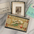 Lot 151 - Antique Box Lot Of Fifteen “Pocket Kodak” Miniature Boarded Photographs Including Dog On Stool, Boys Smoking Pipes, And Man In Workshop, With Camp Alger Flag Pin And American Views Co. Trade Card In John D. Cutter & Co. Chromolithograph Box