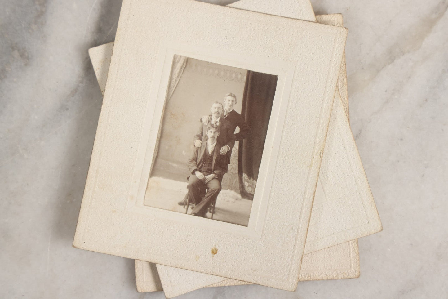 Lot 151 - Antique Box Lot Of Fifteen “Pocket Kodak” Miniature Boarded Photographs Including Dog On Stool, Boys Smoking Pipes, And Man In Workshop, With Camp Alger Flag Pin And American Views Co. Trade Card In John D. Cutter & Co. Chromolithograph Box