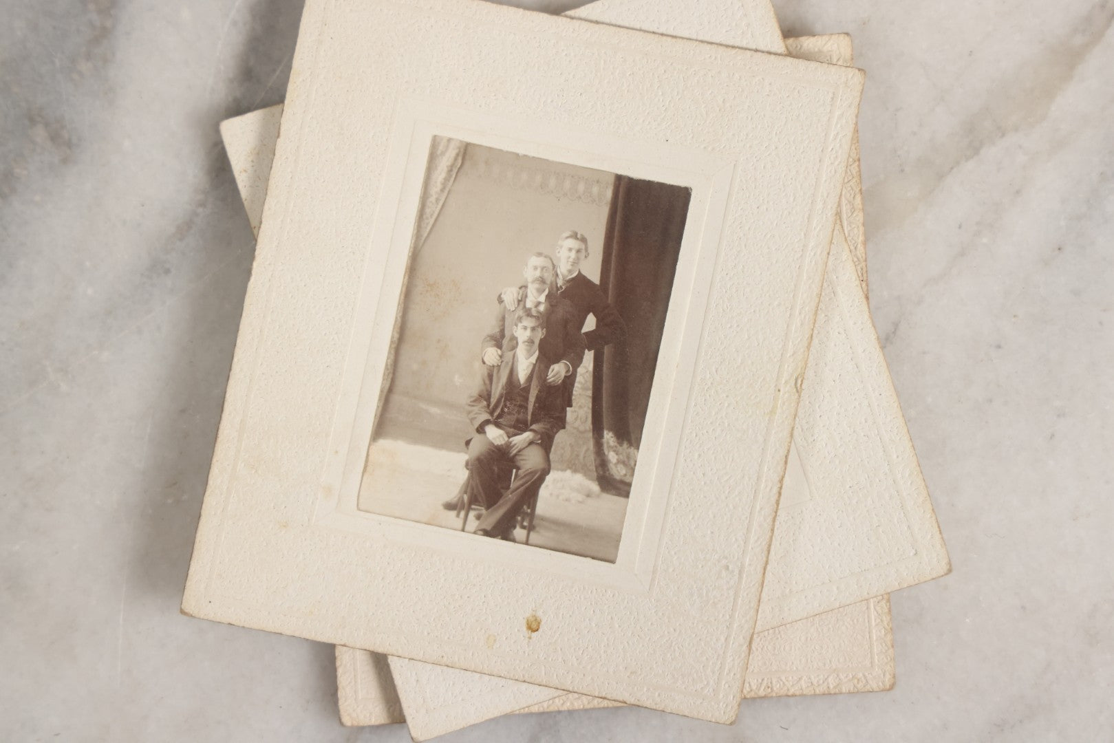 Lot 151 - Antique Box Lot Of Fifteen “Pocket Kodak” Miniature Boarded Photographs Including Dog On Stool, Boys Smoking Pipes, And Man In Workshop, With Camp Alger Flag Pin And American Views Co. Trade Card In John D. Cutter & Co. Chromolithograph Box