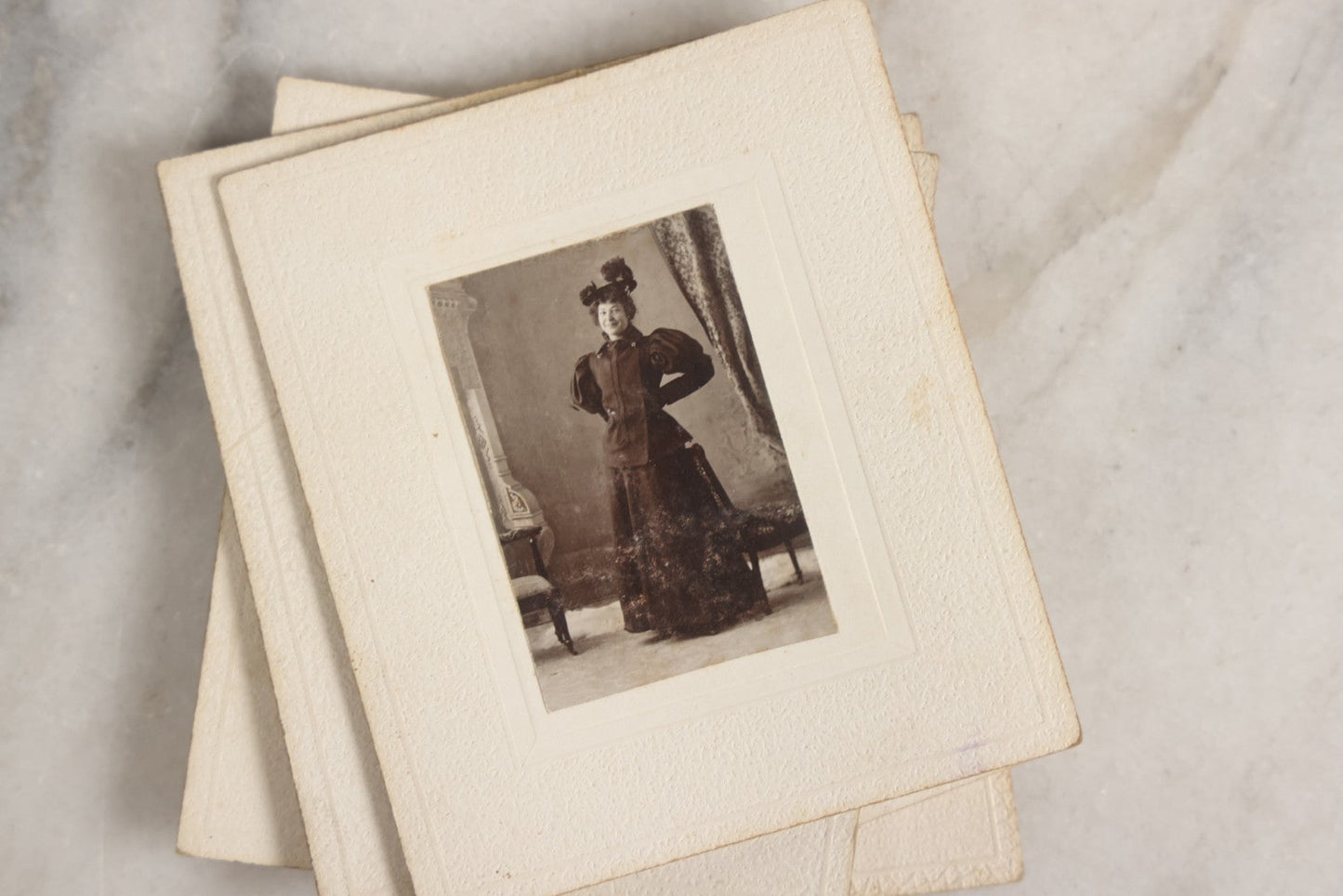 Lot 151 - Antique Box Lot Of Fifteen “Pocket Kodak” Miniature Boarded Photographs Including Dog On Stool, Boys Smoking Pipes, And Man In Workshop, With Camp Alger Flag Pin And American Views Co. Trade Card In John D. Cutter & Co. Chromolithograph Box