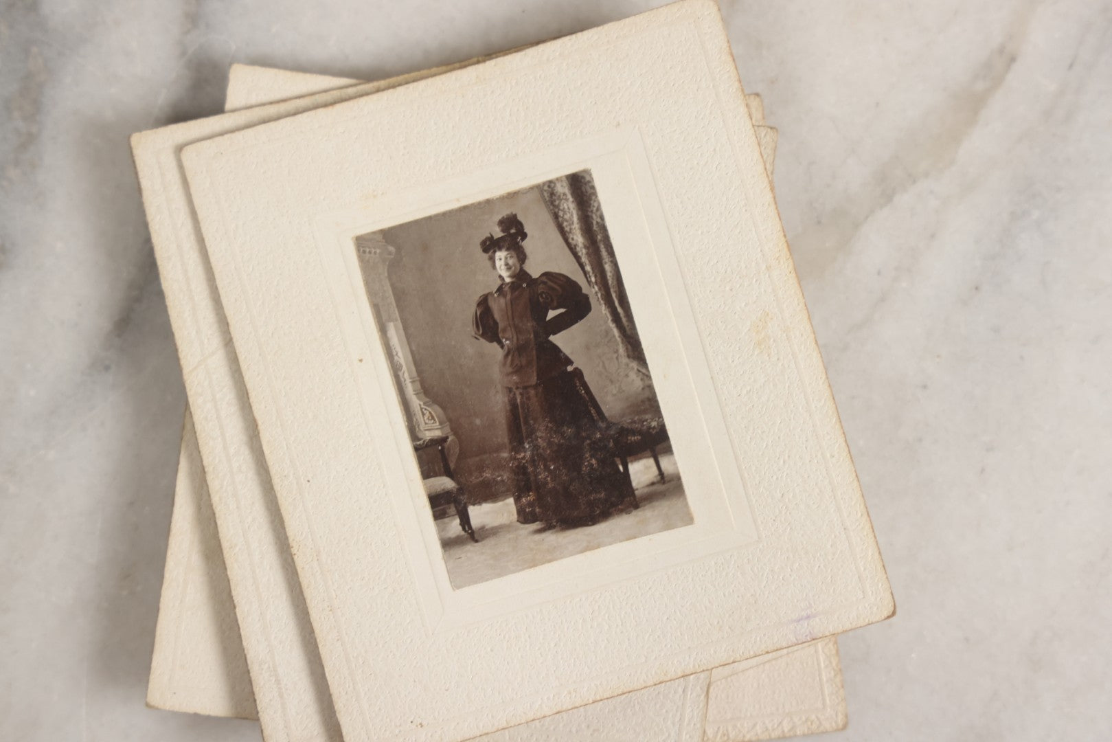 Lot 151 - Antique Box Lot Of Fifteen “Pocket Kodak” Miniature Boarded Photographs Including Dog On Stool, Boys Smoking Pipes, And Man In Workshop, With Camp Alger Flag Pin And American Views Co. Trade Card In John D. Cutter & Co. Chromolithograph Box