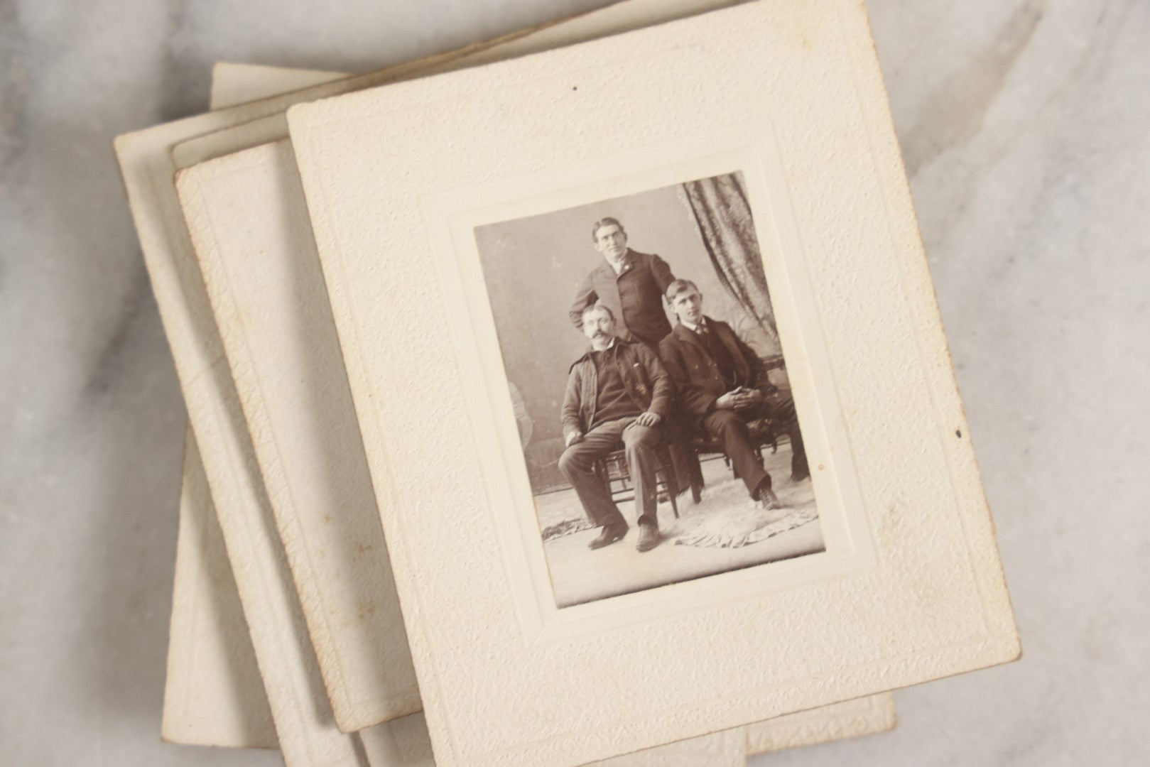 Lot 151 - Antique Box Lot Of Fifteen “Pocket Kodak” Miniature Boarded Photographs Including Dog On Stool, Boys Smoking Pipes, And Man In Workshop, With Camp Alger Flag Pin And American Views Co. Trade Card In John D. Cutter & Co. Chromolithograph Box