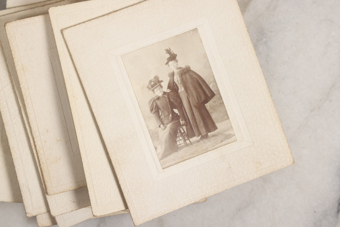 Lot 151 - Antique Box Lot Of Fifteen “Pocket Kodak” Miniature Boarded Photographs Including Dog On Stool, Boys Smoking Pipes, And Man In Workshop, With Camp Alger Flag Pin And American Views Co. Trade Card In John D. Cutter & Co. Chromolithograph Box