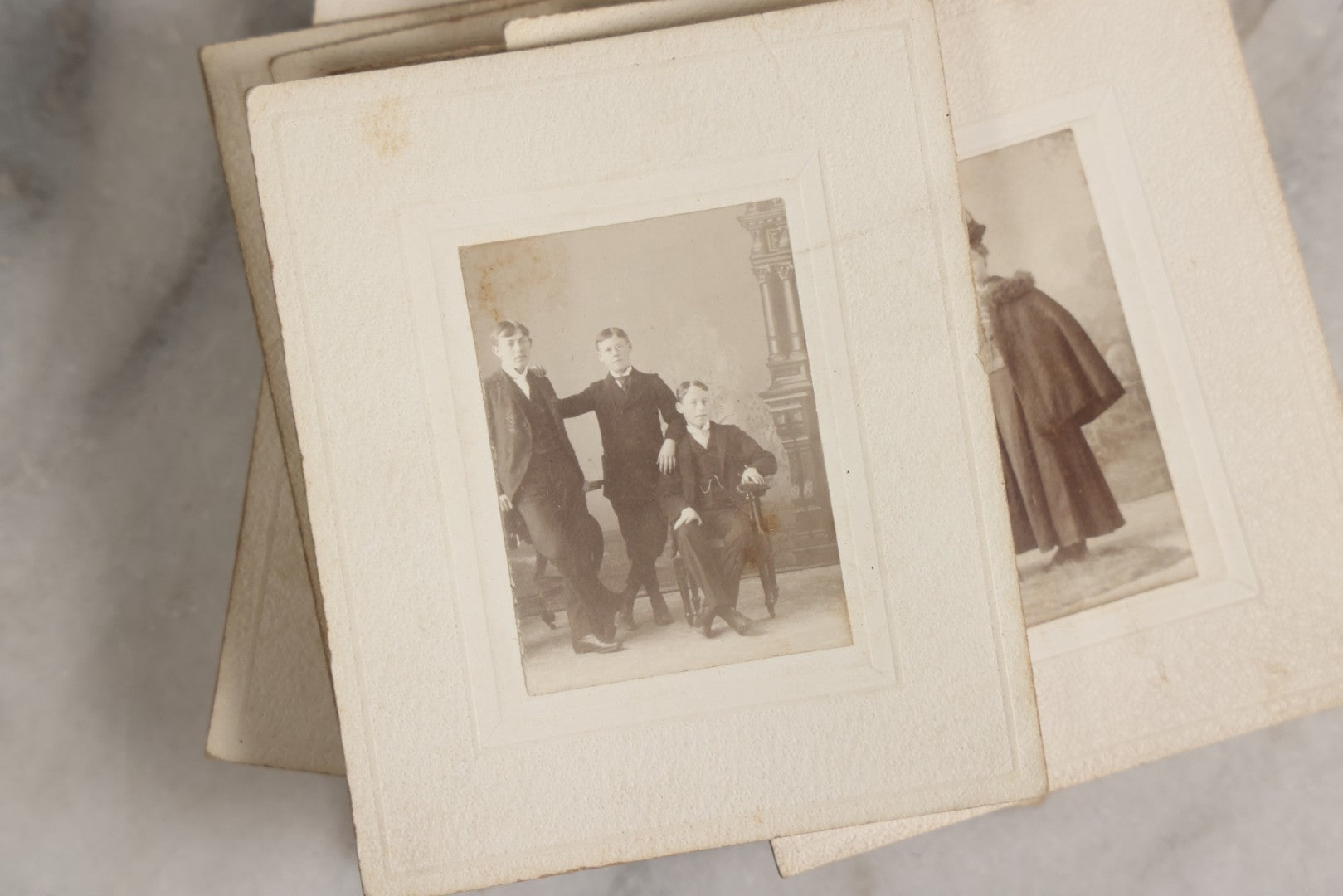 Lot 151 - Antique Box Lot Of Fifteen “Pocket Kodak” Miniature Boarded Photographs Including Dog On Stool, Boys Smoking Pipes, And Man In Workshop, With Camp Alger Flag Pin And American Views Co. Trade Card In John D. Cutter & Co. Chromolithograph Box