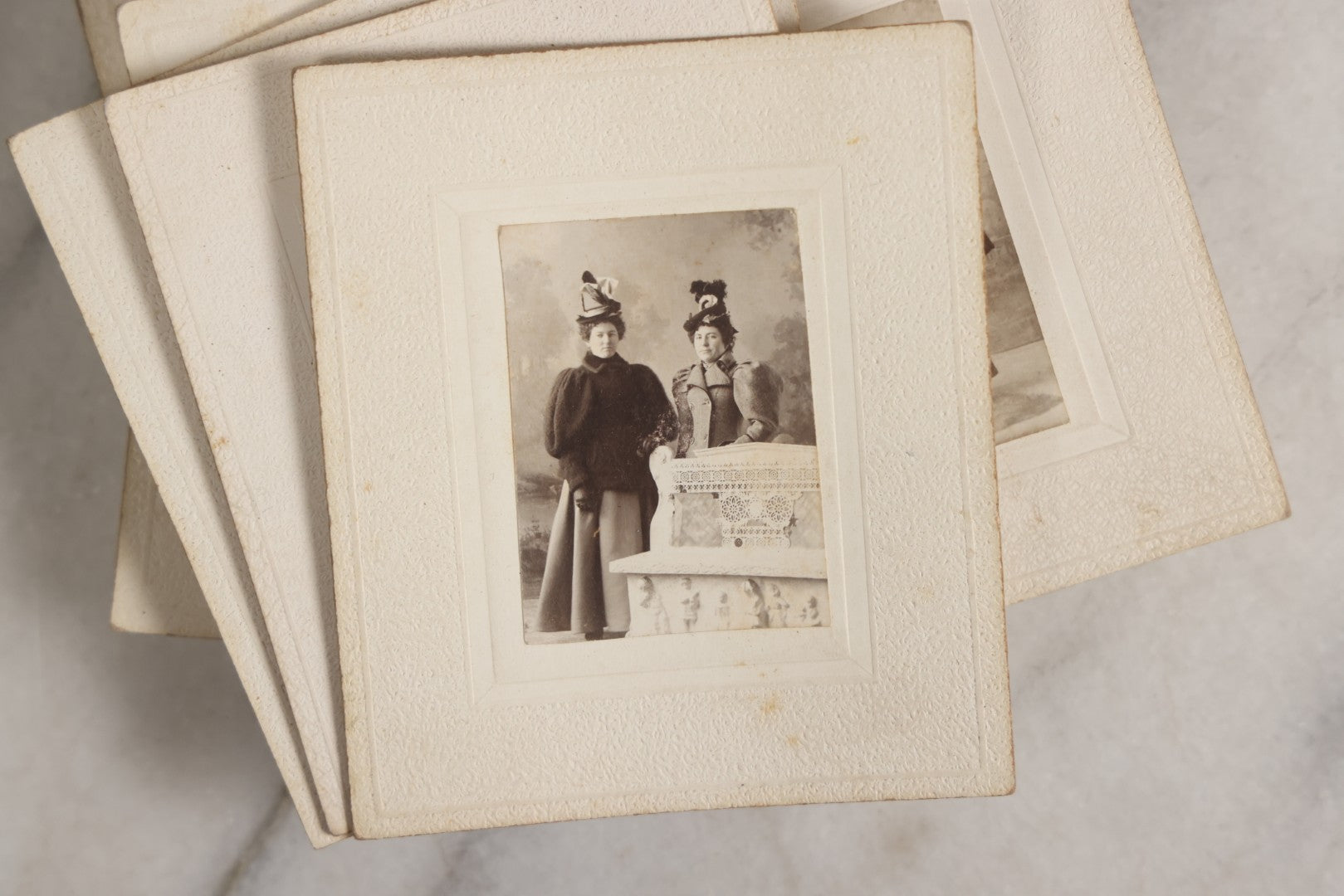 Lot 151 - Antique Box Lot Of Fifteen “Pocket Kodak” Miniature Boarded Photographs Including Dog On Stool, Boys Smoking Pipes, And Man In Workshop, With Camp Alger Flag Pin And American Views Co. Trade Card In John D. Cutter & Co. Chromolithograph Box