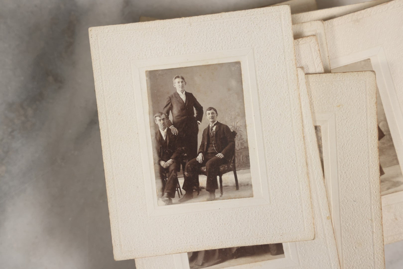 Lot 151 - Antique Box Lot Of Fifteen “Pocket Kodak” Miniature Boarded Photographs Including Dog On Stool, Boys Smoking Pipes, And Man In Workshop, With Camp Alger Flag Pin And American Views Co. Trade Card In John D. Cutter & Co. Chromolithograph Box