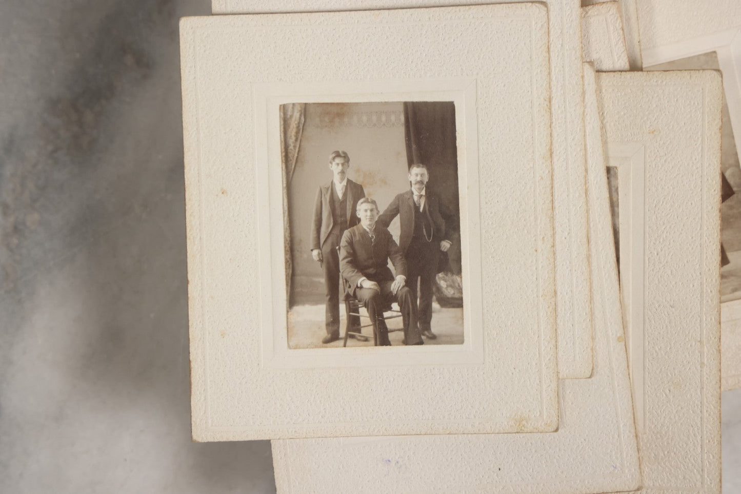 Lot 151 - Antique Box Lot Of Fifteen “Pocket Kodak” Miniature Boarded Photographs Including Dog On Stool, Boys Smoking Pipes, And Man In Workshop, With Camp Alger Flag Pin And American Views Co. Trade Card In John D. Cutter & Co. Chromolithograph Box