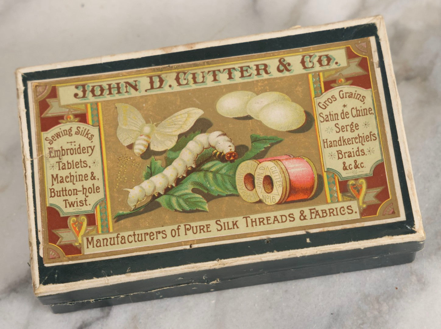 Lot 151 - Antique Box Lot Of Fifteen “Pocket Kodak” Miniature Boarded Photographs Including Dog On Stool, Boys Smoking Pipes, And Man In Workshop, With Camp Alger Flag Pin And American Views Co. Trade Card In John D. Cutter & Co. Chromolithograph Box