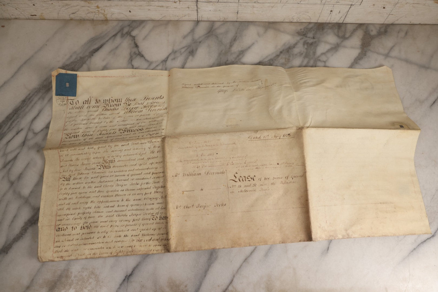 Lot 175 - Antique 1843 Property Indenture Document With Ornate Calligraphy, Red Pinstriping, And Revenue Stamps, Note Holes And Wear To Folded Edges And Corners