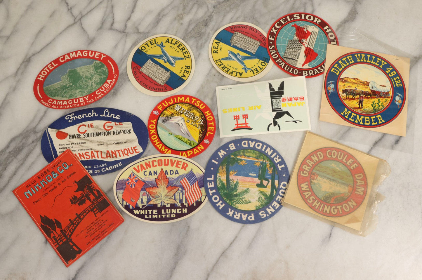 Lot 179 - Grouping Of 12 Vintage Travel Decals Including Fujimatsu Hotel Yokohama Japan, Hotel Camaguey Cuba, Grand Coulee Dam Washington, Death Valley 49ers Member