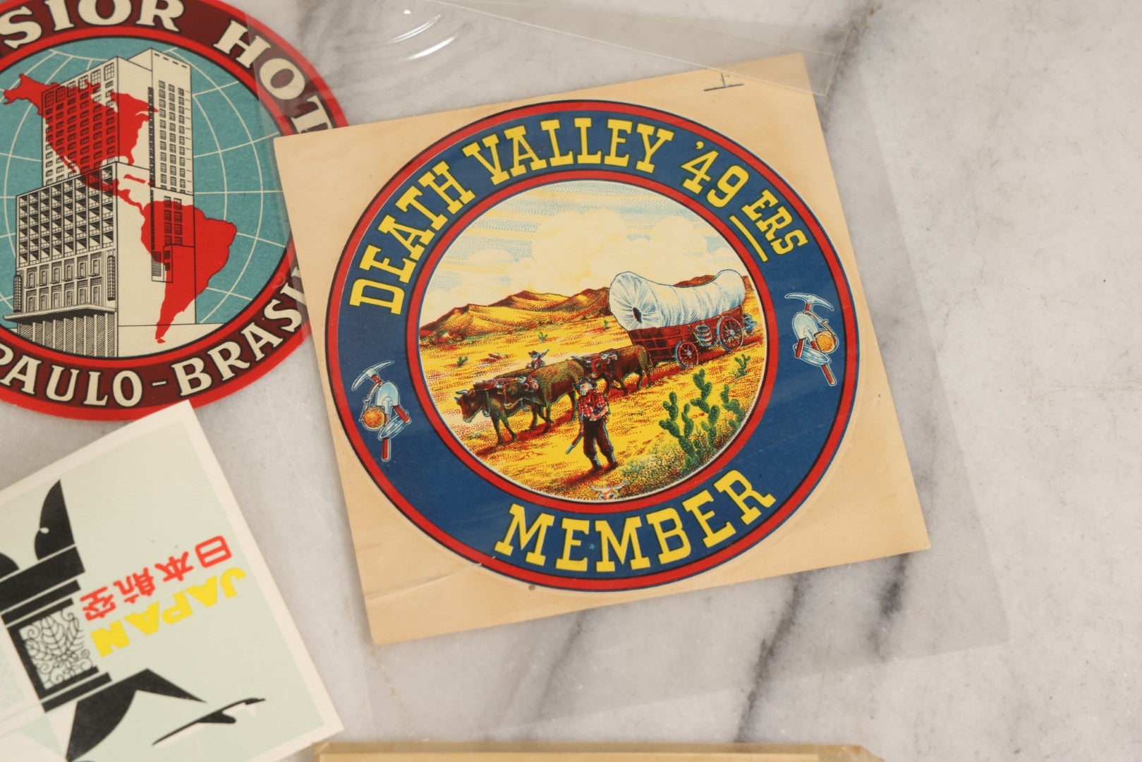 Lot 179 - Grouping Of 12 Vintage Travel Decals Including Fujimatsu Hotel Yokohama Japan, Hotel Camaguey Cuba, Grand Coulee Dam Washington, Death Valley 49ers Member