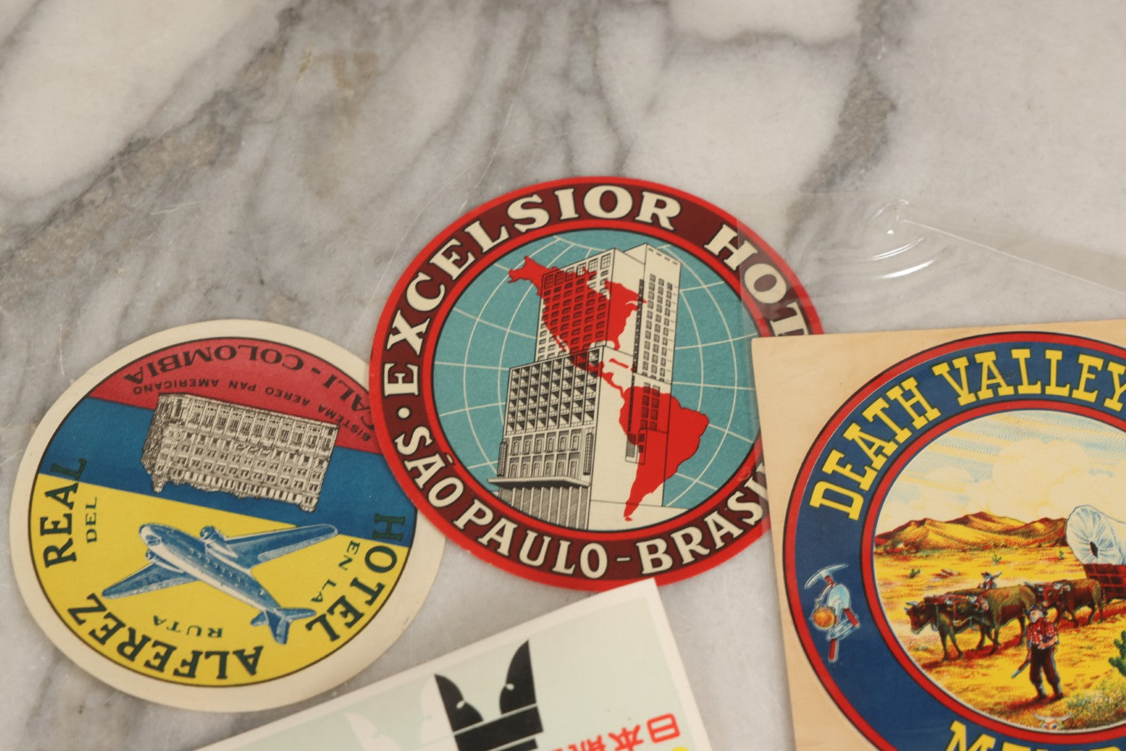 Lot 179 - Grouping Of 12 Vintage Travel Decals Including Fujimatsu Hotel Yokohama Japan, Hotel Camaguey Cuba, Grand Coulee Dam Washington, Death Valley 49ers Member