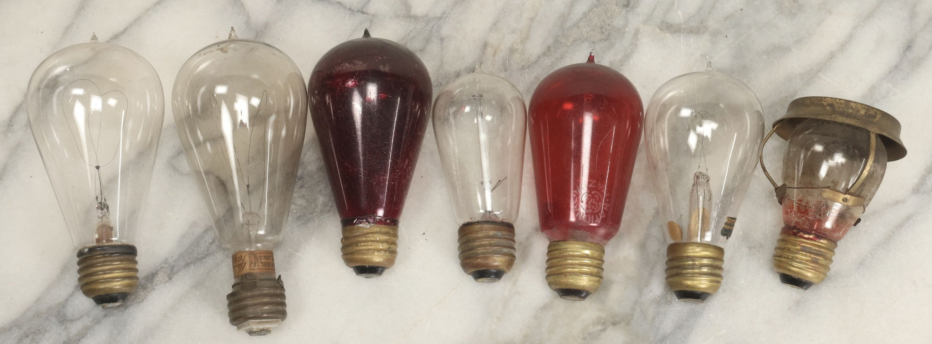 Lot 012 - Grouping Of Seven Antique Edison Style Incandescent Light Bulbs With Mixed Makers Including Bryan Marsh Imperial, Miller Patent 1902, National Mazda General Electric, Red And Clear Examples