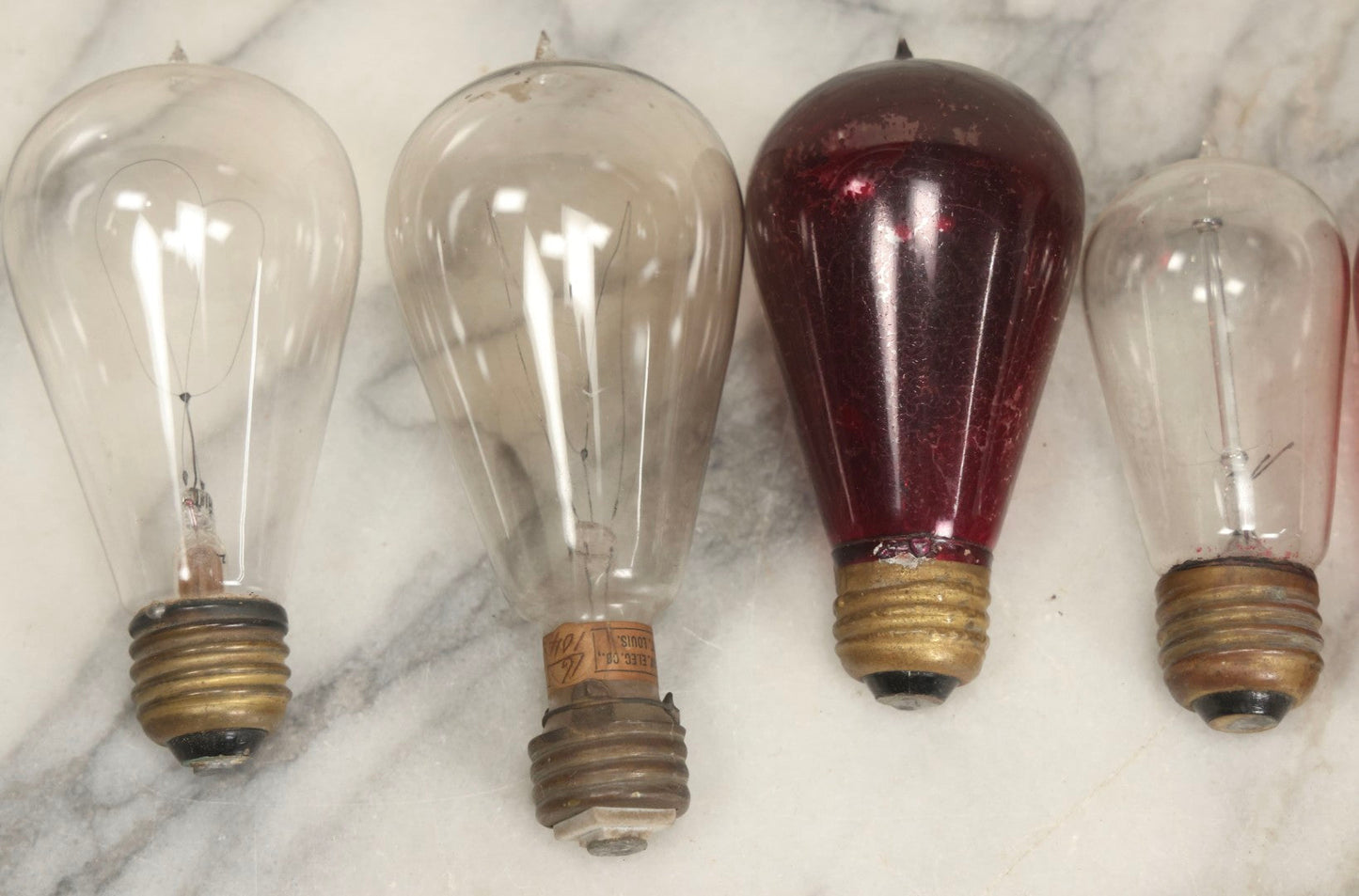 Lot 012 - Grouping Of Seven Antique Edison Style Incandescent Light Bulbs With Mixed Makers Including Bryan Marsh Imperial, Miller Patent 1902, National Mazda General Electric, Red And Clear Examples