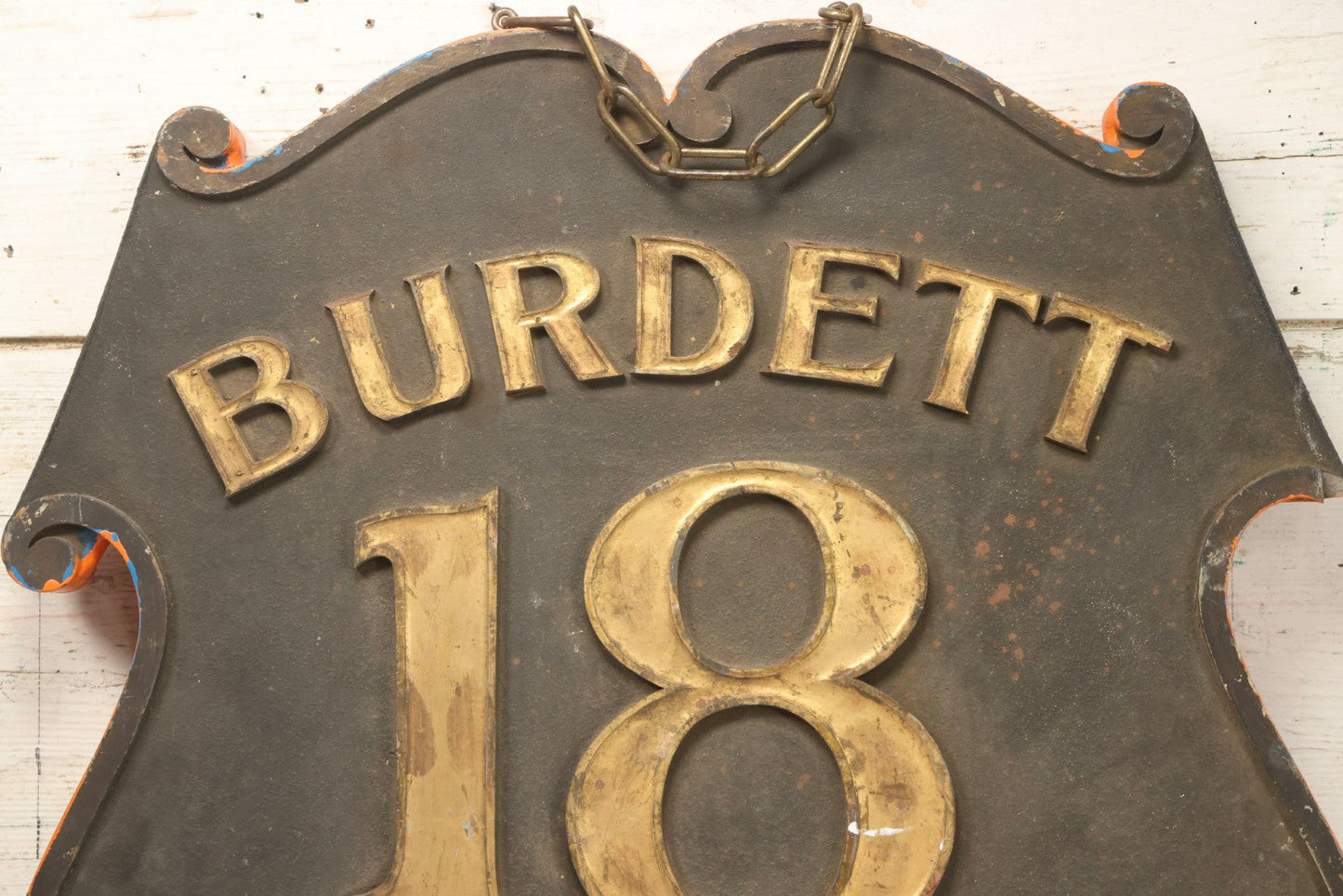 Lot 034 - Double-Sided Wooden Shield-Form Sign With Raised Letters “Burdett 18 College” And Modern Repurposed Side Painted “Last Chance Saloon," Note Missing Corner Scroll Piece And Large Crack In Other Scroll Corner, 25-1/2" x 26"