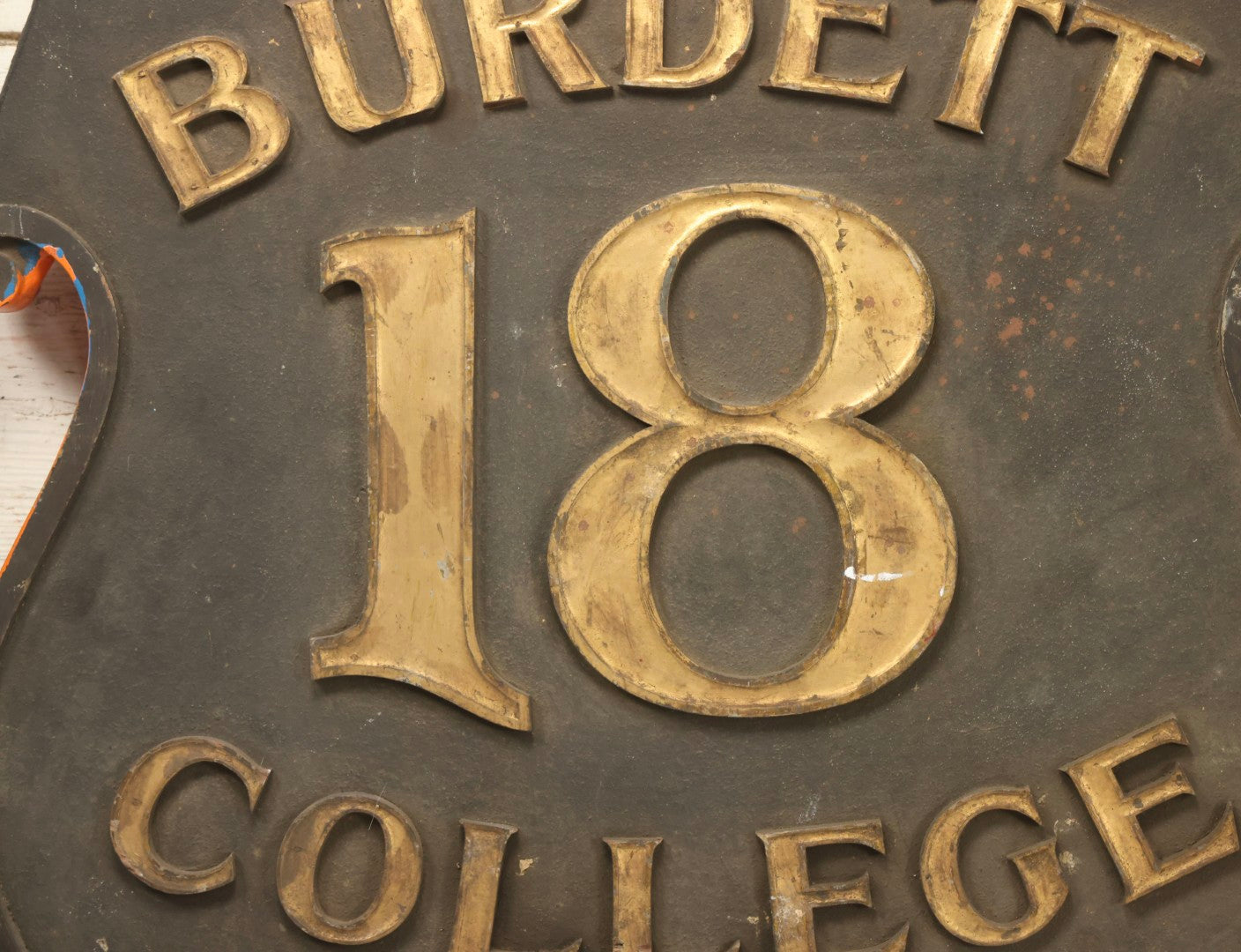 Lot 034 - Double-Sided Wooden Shield-Form Sign With Raised Letters “Burdett 18 College” And Modern Repurposed Side Painted “Last Chance Saloon," Note Missing Corner Scroll Piece And Large Crack In Other Scroll Corner, 25-1/2" x 26"