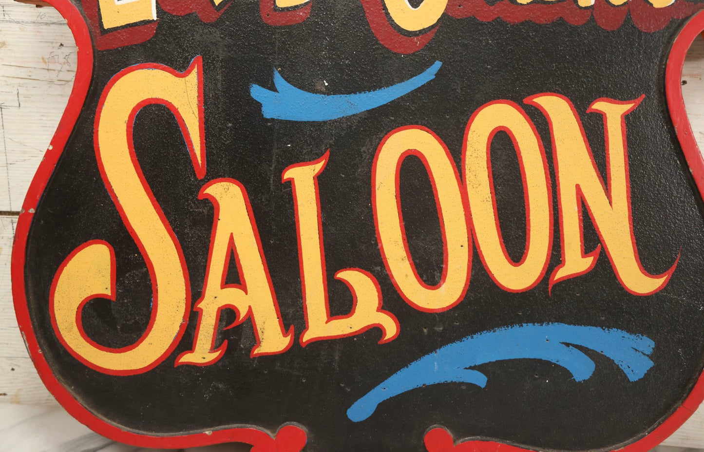 Lot 034 - Double-Sided Wooden Shield-Form Sign With Raised Letters “Burdett 18 College” And Modern Repurposed Side Painted “Last Chance Saloon," Note Missing Corner Scroll Piece And Large Crack In Other Scroll Corner, 25-1/2" x 26"