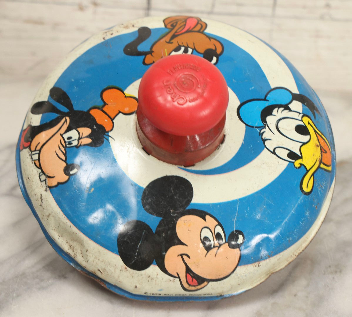 Lot 055 - Vintage Tin Lithographed Disney Characters Pump Action Toy Spinning Top With Mickey Mouse, Goofy, Pluto, And Donald Duck, Chein Playthings, 1973, 6-3/4" Diameter