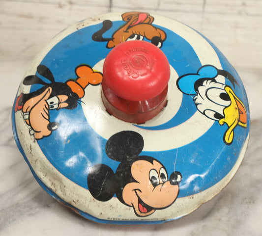 Lot 055 - Vintage Tin Lithographed Disney Characters Pump Action Toy Spinning Top With Mickey Mouse, Goofy, Pluto, And Donald Duck, Chein Playthings, 1973, 6-3/4" Diameter