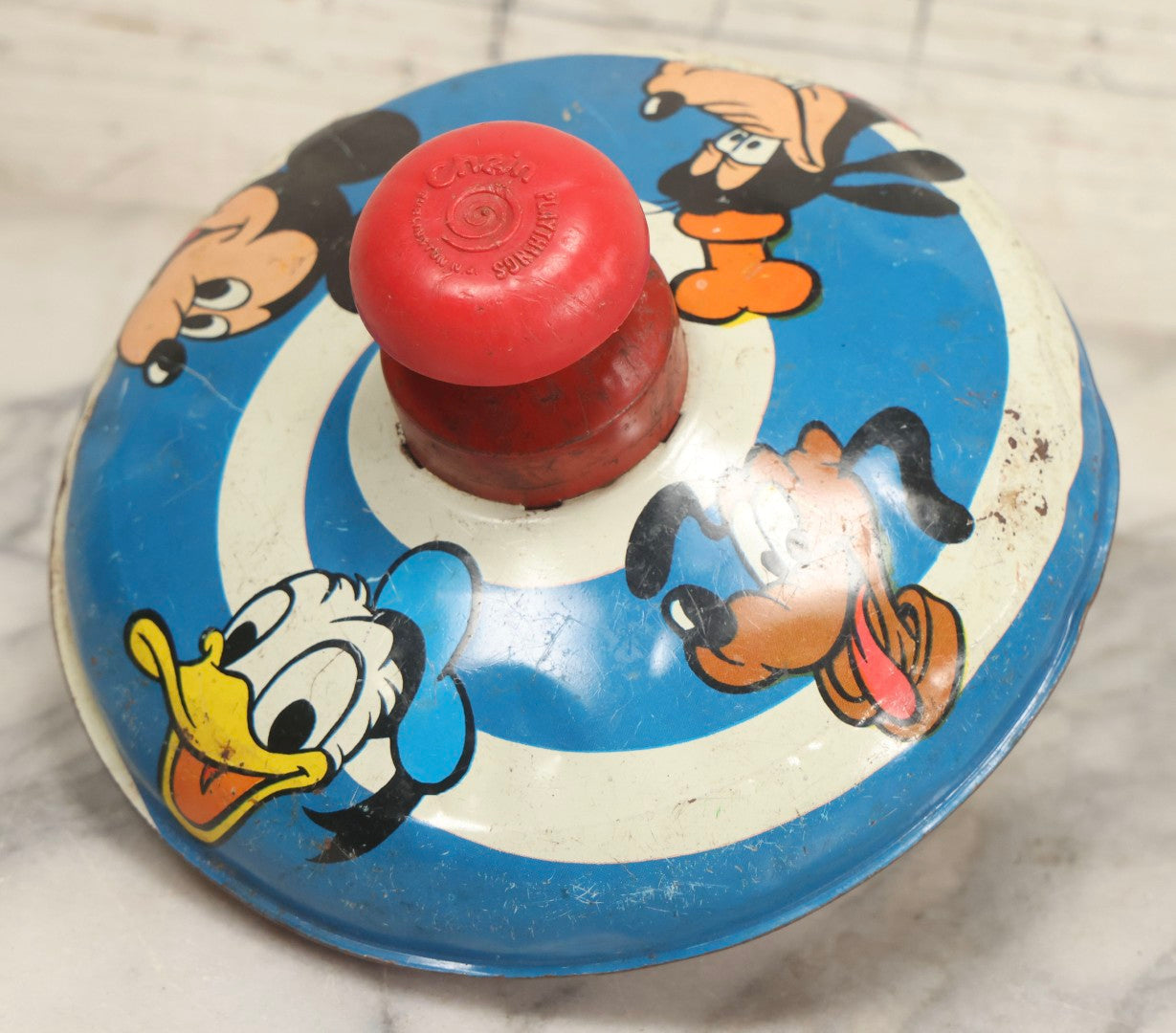 Lot 055 - Vintage Tin Lithographed Disney Characters Pump Action Toy Spinning Top With Mickey Mouse, Goofy, Pluto, And Donald Duck, Chein Playthings, 1973, 6-3/4" Diameter