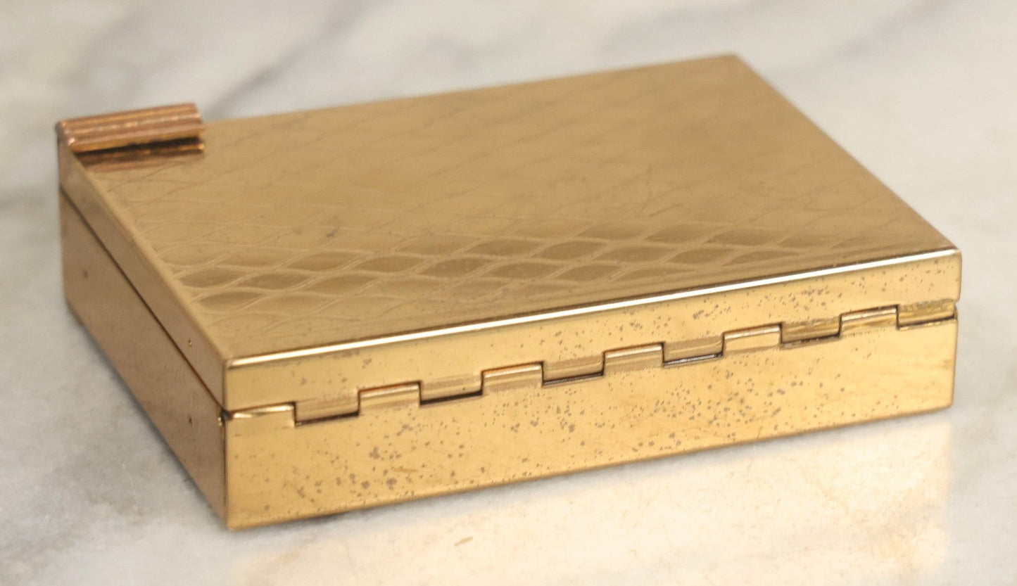 Lot 059 - Vintage Volupte Brass Makeup Compact With Pull-Out Lipstick Holder And Wind Up Musical Box, Made In U.S.A..