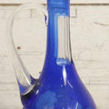 Lot 063 - Vintage Cobalt Blue Cut-To-Clear Glass Decanter With Floral Decoration, Applied Handle, And Faceted Stopper