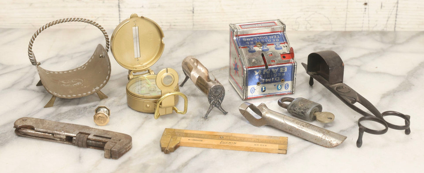 Lot 067 - Grouping Of Eleven Vintage Metal Smalls Including Compass, Wick Trimmer, Measuring Tools, Advertising Opener, Jewelry, Padlock, Tin Toy Bank, And Miniatures
