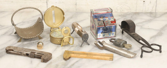 Lot 067 - Grouping Of Eleven Vintage Metal Smalls Including Compass, Wick Trimmer, Measuring Tools, Advertising Opener, Jewelry, Padlock, Tin Toy Bank, And Miniatures