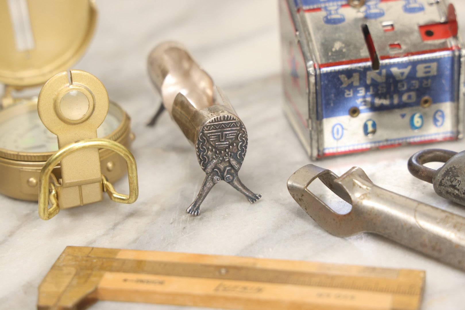 Lot 067 - Grouping Of Eleven Vintage Metal Smalls Including Compass, Wick Trimmer, Measuring Tools, Advertising Opener, Jewelry, Padlock, Tin Toy Bank, And Miniatures