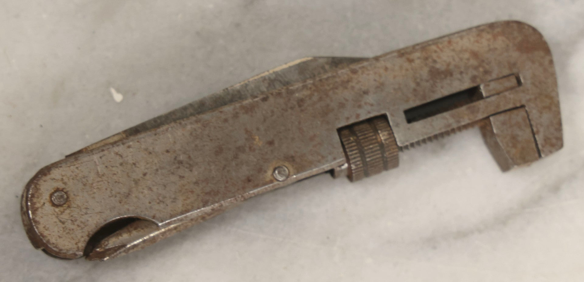 Lot 067 - Grouping Of Eleven Vintage Metal Smalls Including Compass, Wick Trimmer, Measuring Tools, Advertising Opener, Jewelry, Padlock, Tin Toy Bank, And Miniatures