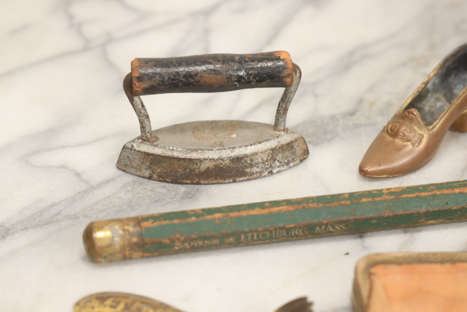 Lot 068 - Grouping Of Seven Mixed Vintage Smalls Including Miniature Shoe, Coin Purse, Mini Cast Iron Sad Iron, Jumbo Fitchburg, Mass Souvenir Pencil, Key Holder, And Advertising Spoon