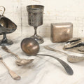 Lot 069 - Eight-Piece Vintage Silverplate Tableware And Accessories Lot Including Engraved Chalice, “The Crumber” Table Sweeper, Sugar Scuttle, Utensils, And 1938-1963 25th Anniversary Presentation Box