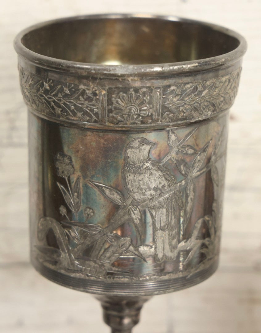 Lot 069 - Eight-Piece Vintage Silverplate Tableware And Accessories Lot Including Engraved Chalice, “The Crumber” Table Sweeper, Sugar Scuttle, Utensils, And 1938-1963 25th Anniversary Presentation Box