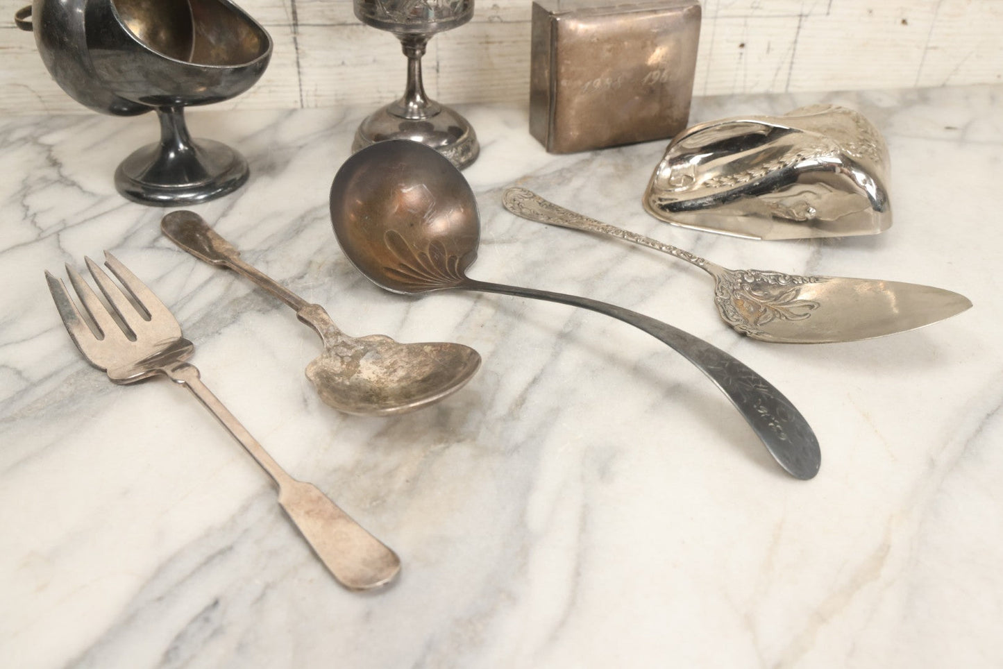 Lot 069 - Eight-Piece Vintage Silverplate Tableware And Accessories Lot Including Engraved Chalice, “The Crumber” Table Sweeper, Sugar Scuttle, Utensils, And 1938-1963 25th Anniversary Presentation Box