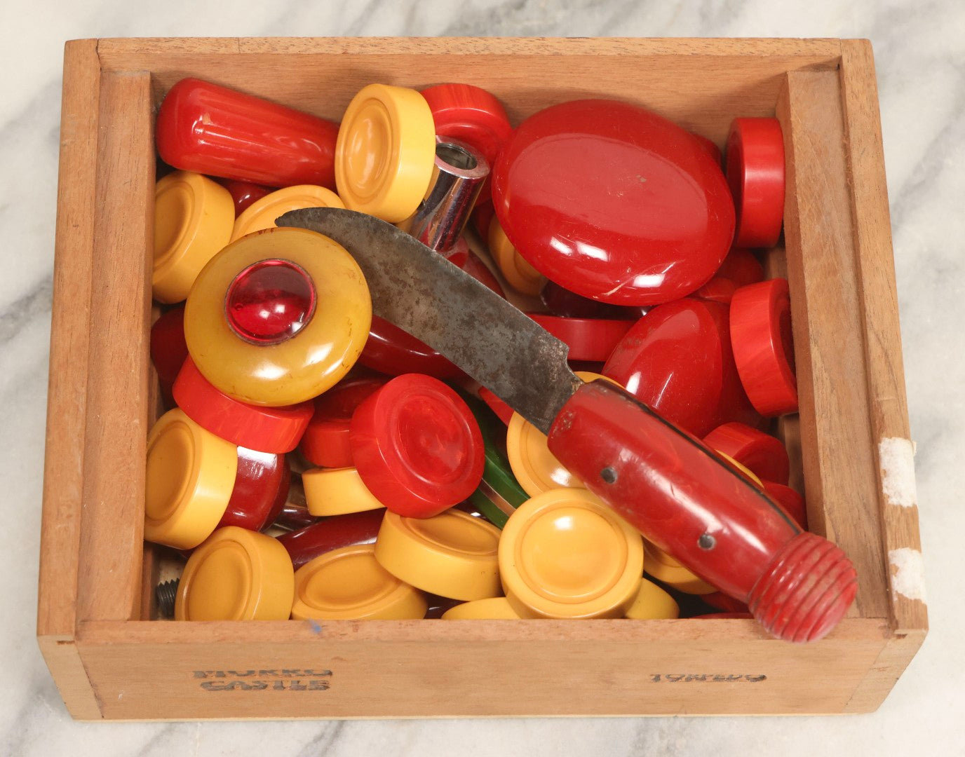 Lot 071 - Grouping Of Vintage Red And Yellow Bakelite And Plastic Game Pieces, Knobs, Shifter Knob, Knife, And More, As Found