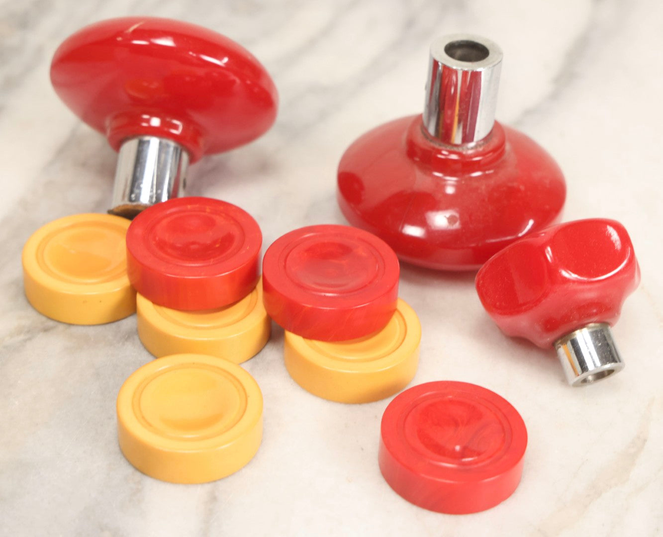 Lot 071 - Grouping Of Vintage Red And Yellow Bakelite And Plastic Game Pieces, Knobs, Shifter Knob, Knife, And More, As Found