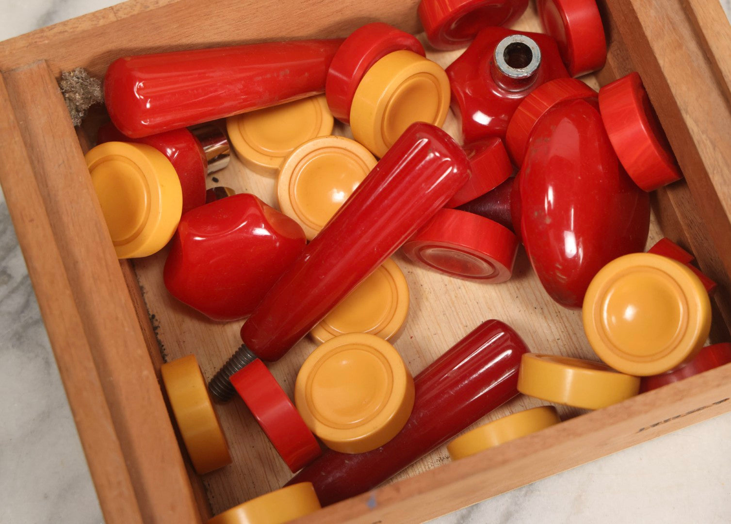 Lot 071 - Grouping Of Vintage Red And Yellow Bakelite And Plastic Game Pieces, Knobs, Shifter Knob, Knife, And More, As Found