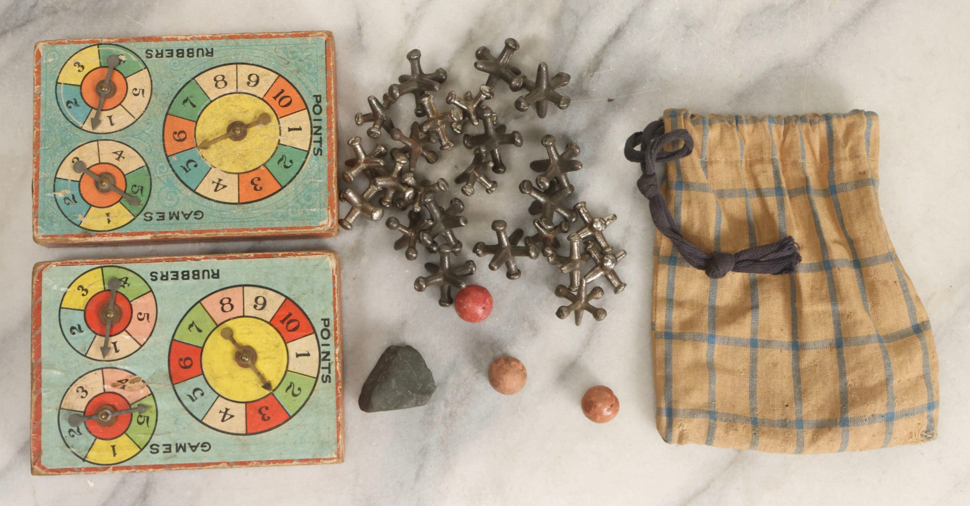 Lot 072 - Grouping Of Vintage Children's Small Games And Toys With Drawstring Sack, Jacks, Clay Marbles, And Two Wood Block Multi-Function Spinners With Paper Dials