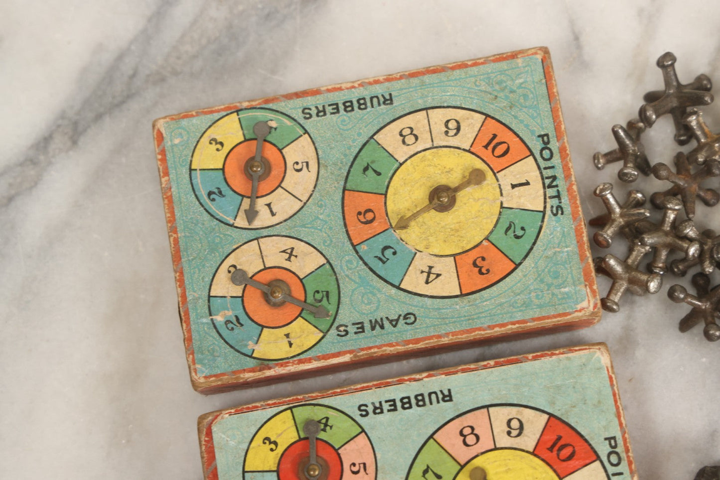 Lot 072 - Grouping Of Vintage Children's Small Games And Toys With Drawstring Sack, Jacks, Clay Marbles, And Two Wood Block Multi-Function Spinners With Paper Dials