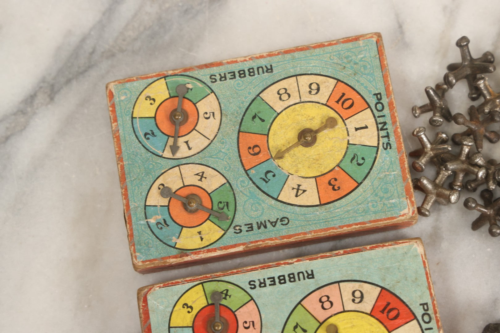 Lot 072 - Grouping Of Vintage Children's Small Games And Toys With Drawstring Sack, Jacks, Clay Marbles, And Two Wood Block Multi-Function Spinners With Paper Dials