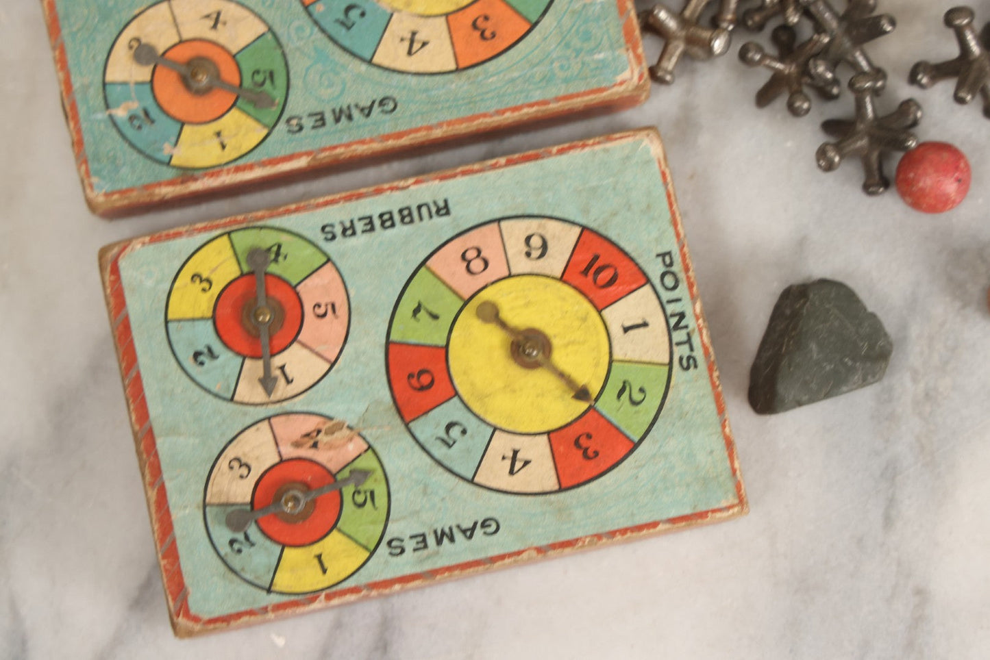 Lot 072 - Grouping Of Vintage Children's Small Games And Toys With Drawstring Sack, Jacks, Clay Marbles, And Two Wood Block Multi-Function Spinners With Paper Dials