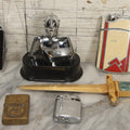 Lot 075 - Grouping Of Seven Vintage Lighters For Parts Or Repair, Including Knight Armor Table Lighter, Ronson Case Lighters, Camel Zippo, And Novelty Examples