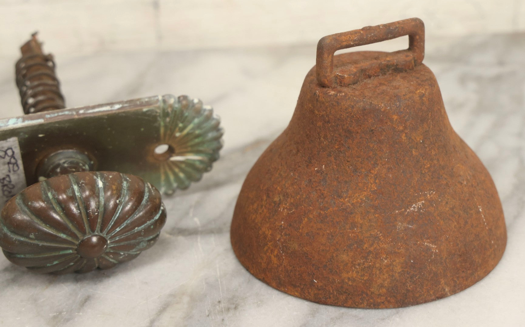 Lot 077 - Grouping Of Four Antique Hardware Items Including Metal Bell, Door Knobs, Escutcheon, And Autodesk Steering Wheel Bracket