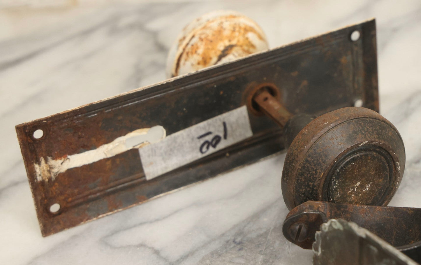 Lot 077 - Grouping Of Four Antique Hardware Items Including Metal Bell, Door Knobs, Escutcheon, And Autodesk Steering Wheel Bracket